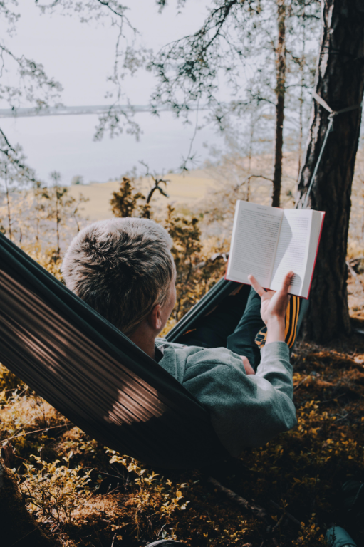 Woman reading book in hammock