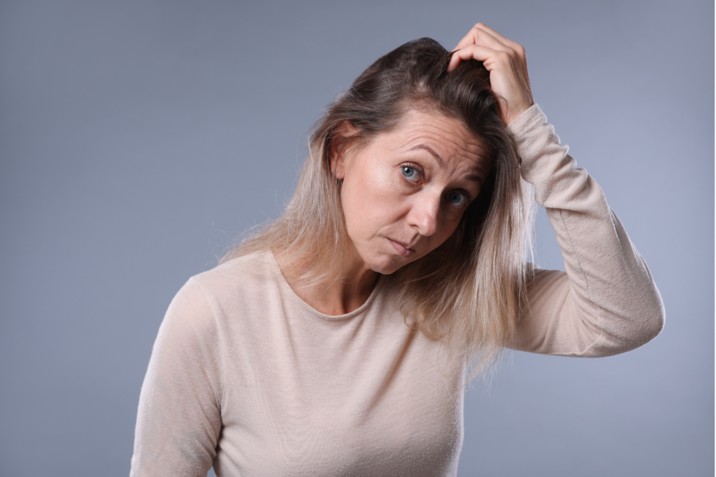Woman checking her Thinning hair during menopause
